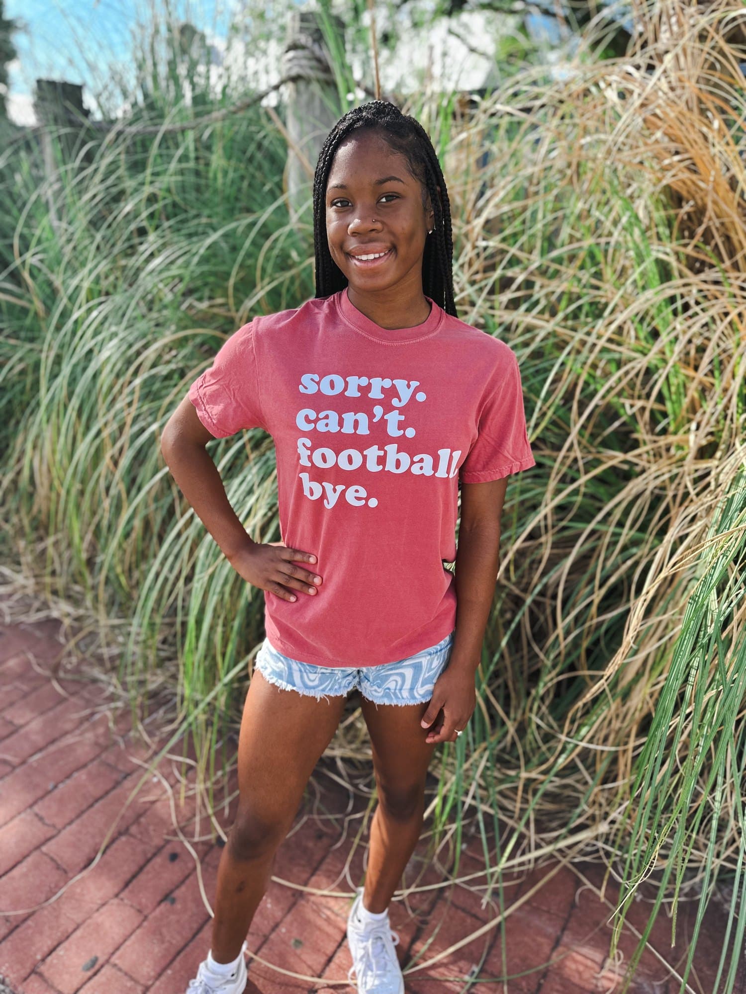 A game day graphic tee that reads sorry, can't, football, bye