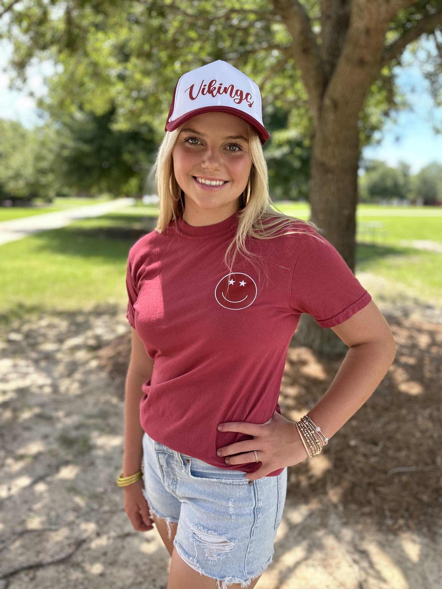 A Lowndes Vikings fan in a Vikings rope cap and a garment-dyed tee