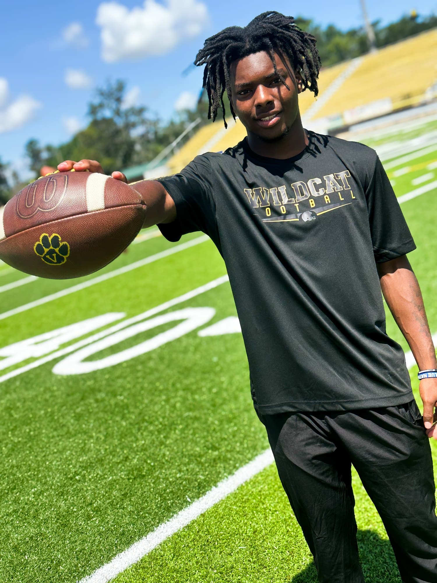 A Valdosta player on the field in a Wildcat Football tee