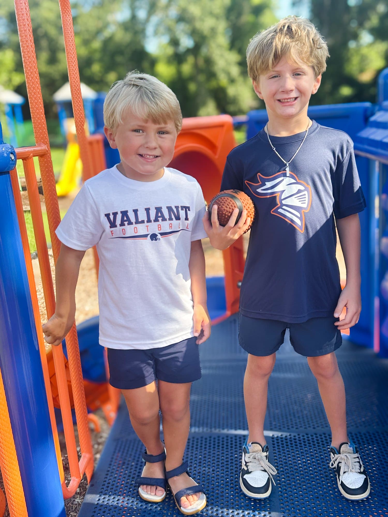 Two young Valwood fans in Valiant Football and knight-logo tees